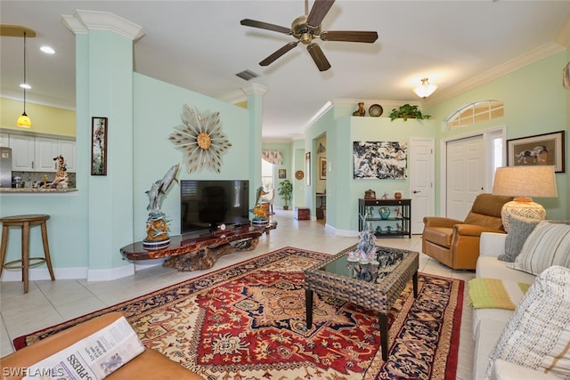 living room featuring light tile patterned floors, decorative columns, ceiling fan, and ornamental molding