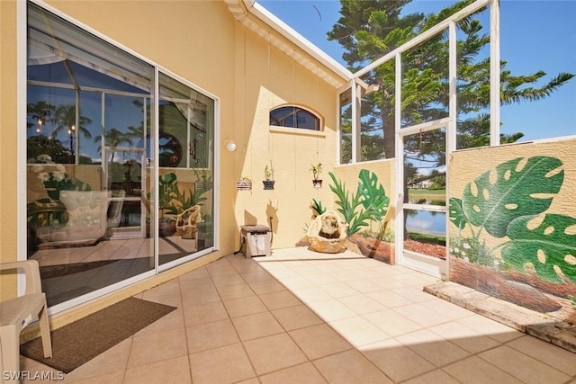 sunroom / solarium featuring a water view