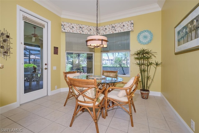 dining area with light tile patterned floors and crown molding