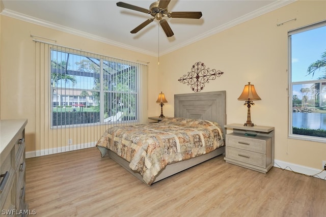 bedroom featuring ceiling fan, ornamental molding, light hardwood / wood-style flooring, and multiple windows