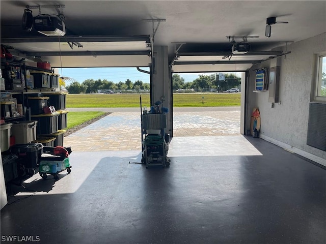 garage featuring a lawn and a garage door opener