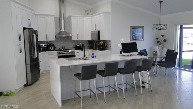 kitchen with decorative light fixtures, white cabinets, stainless steel appliances, and lofted ceiling