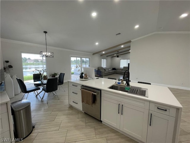 kitchen featuring white cabinetry, hanging light fixtures, a wealth of natural light, stainless steel dishwasher, and sink