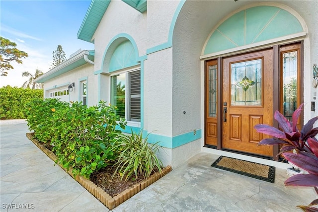 view of exterior entry with a garage