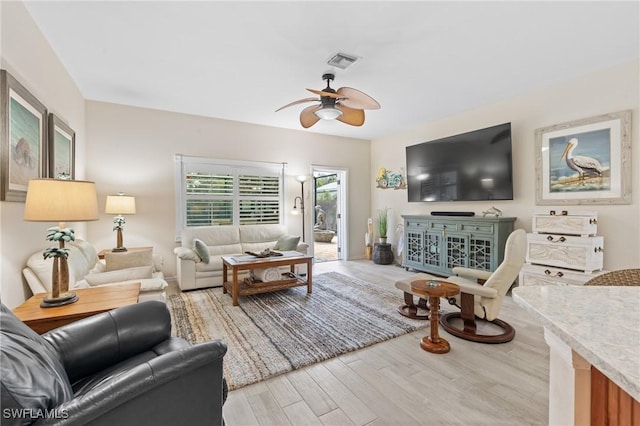 living room with hardwood / wood-style floors and ceiling fan