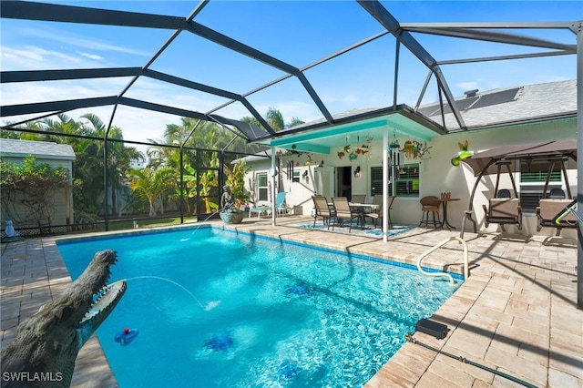 view of pool featuring ceiling fan, a lanai, and a patio