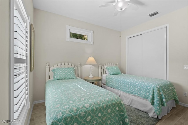 bedroom with a closet, ceiling fan, and light hardwood / wood-style floors