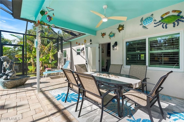 view of patio / terrace with ceiling fan and glass enclosure