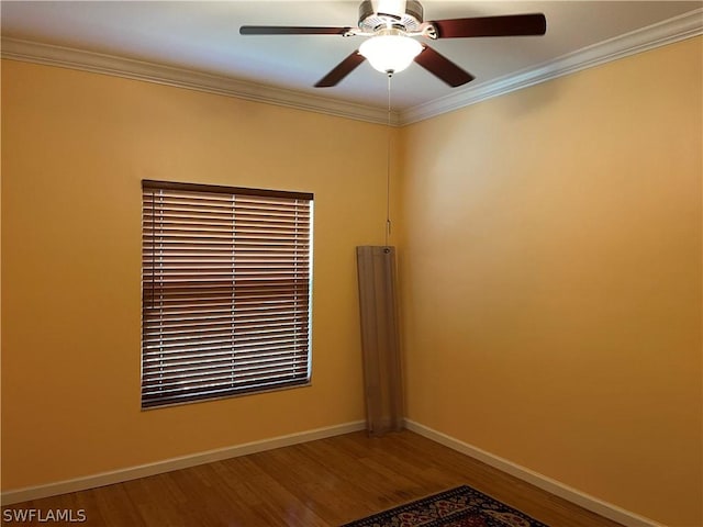 empty room featuring hardwood / wood-style floors, ceiling fan, and crown molding