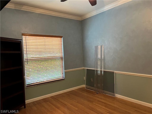 unfurnished room featuring crown molding and wood-type flooring