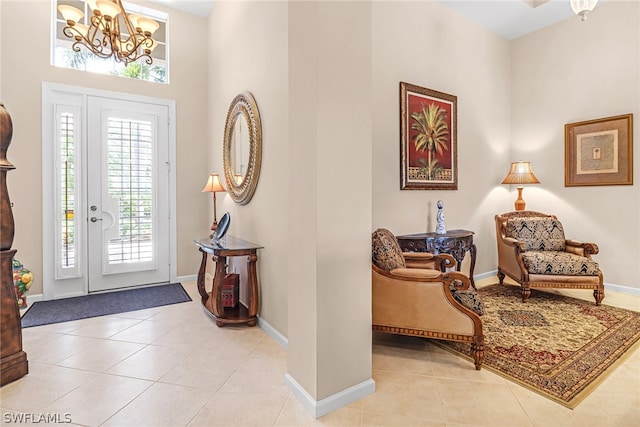 foyer featuring light tile patterned floors and an inviting chandelier