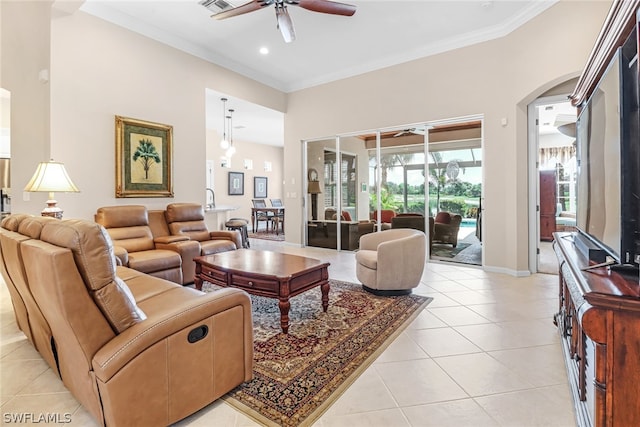 living room with ceiling fan, ornamental molding, and light tile patterned flooring