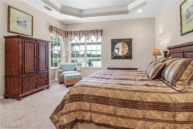 bedroom with light colored carpet, ornamental molding, and a tray ceiling