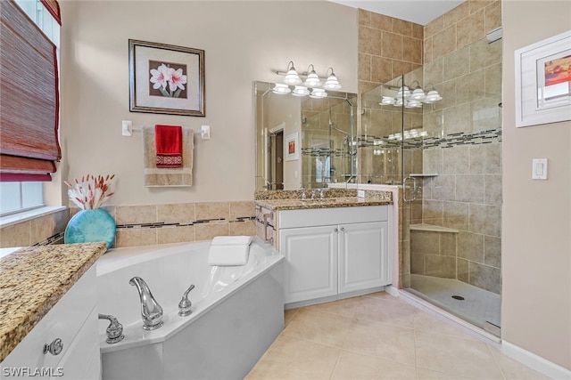 bathroom featuring plus walk in shower, vanity, and tile patterned floors