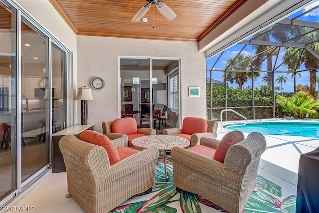 view of patio / terrace with a lanai, ceiling fan, and an outdoor living space