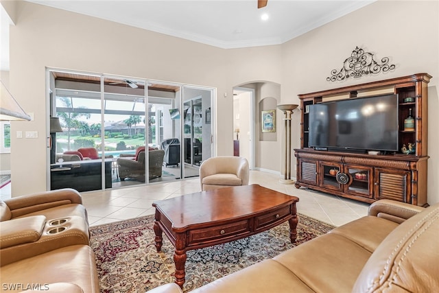 tiled living room featuring ceiling fan and ornamental molding