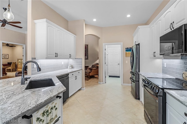 kitchen with pendant lighting, sink, white cabinetry, and black appliances