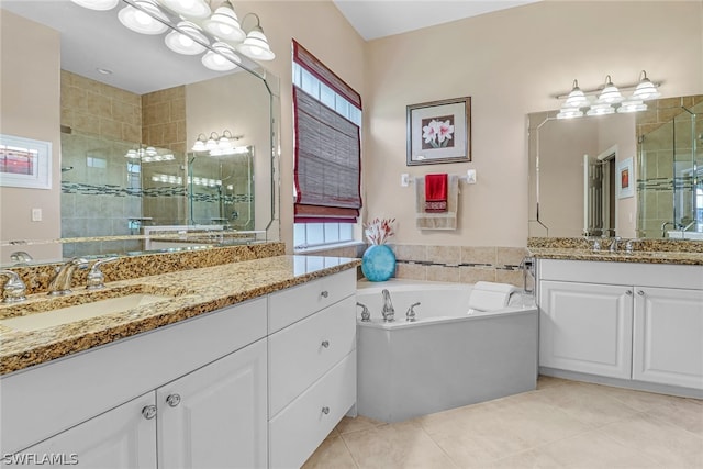 bathroom with tile patterned floors, vanity, separate shower and tub, and a wealth of natural light