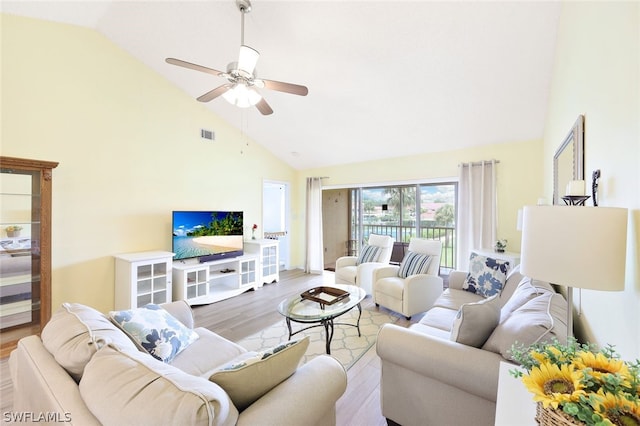 living room featuring ceiling fan, high vaulted ceiling, and light hardwood / wood-style flooring