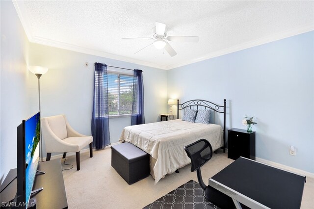 carpeted bedroom with ceiling fan, a textured ceiling, and ornamental molding