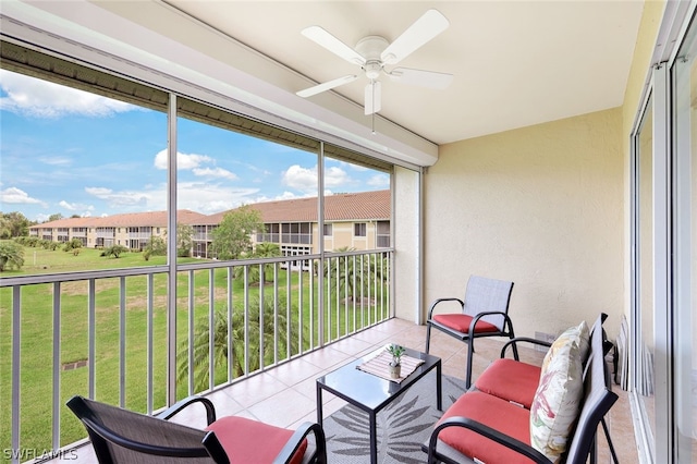 sunroom / solarium featuring ceiling fan