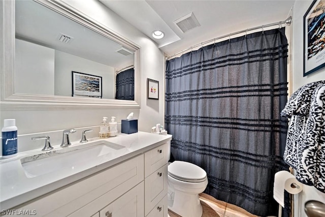 bathroom with toilet, vanity, and a shower with curtain