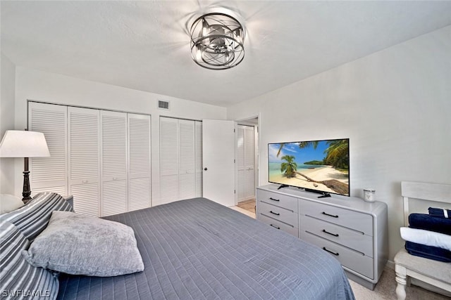 carpeted bedroom with two closets