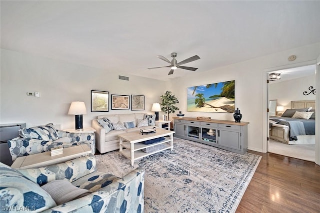 living room with ceiling fan and hardwood / wood-style flooring