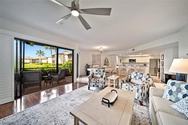 living room featuring hardwood / wood-style flooring and ceiling fan