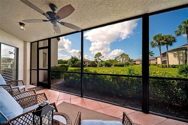 sunroom / solarium featuring ceiling fan