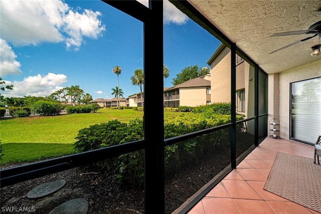 unfurnished sunroom with ceiling fan