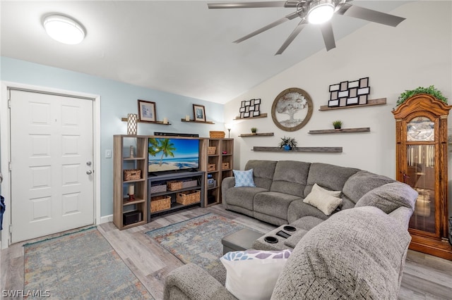 living room with lofted ceiling, ceiling fan, and light hardwood / wood-style flooring