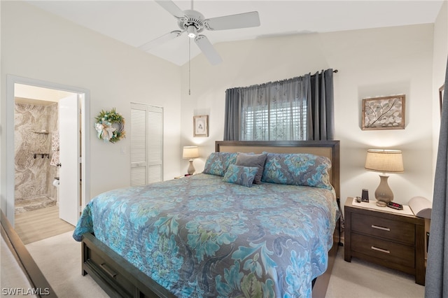 bedroom featuring lofted ceiling, ceiling fan, a closet, and ensuite bathroom