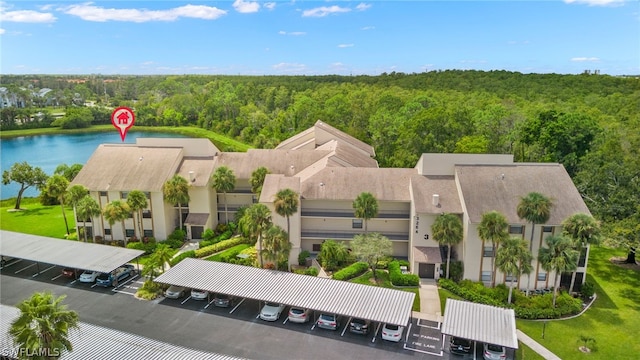 drone / aerial view featuring a water view and a view of trees