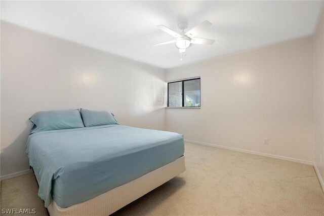 bedroom featuring ceiling fan and light carpet