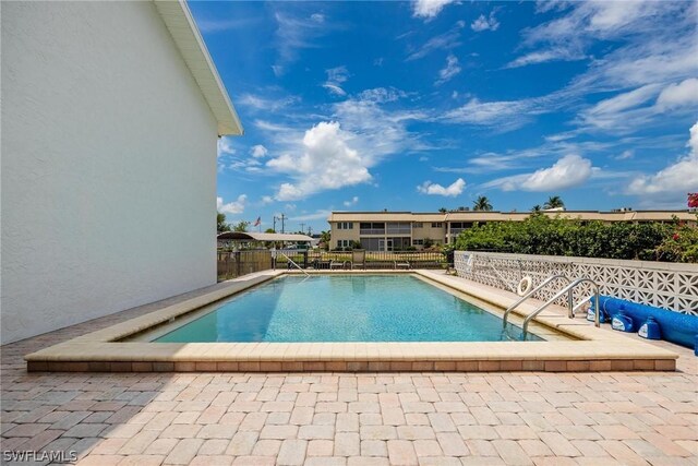 view of swimming pool with a patio area