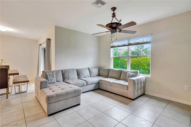 living room featuring light tile patterned floors and ceiling fan