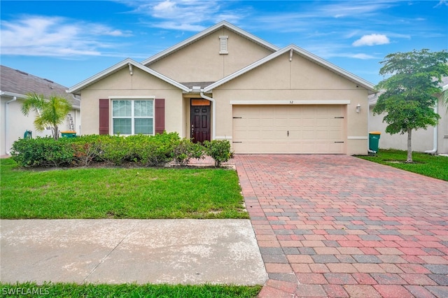 single story home featuring a garage and a front lawn