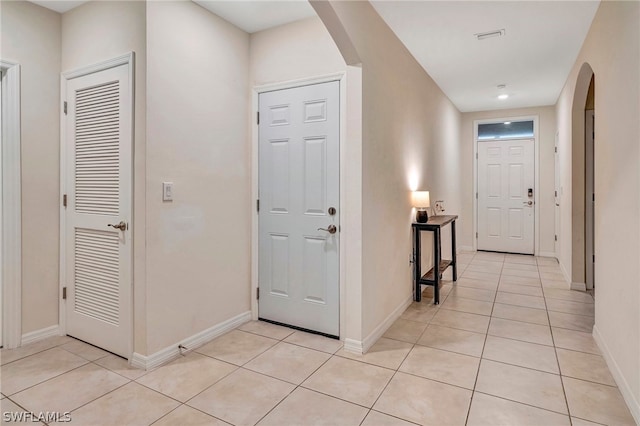 hallway featuring light tile floors