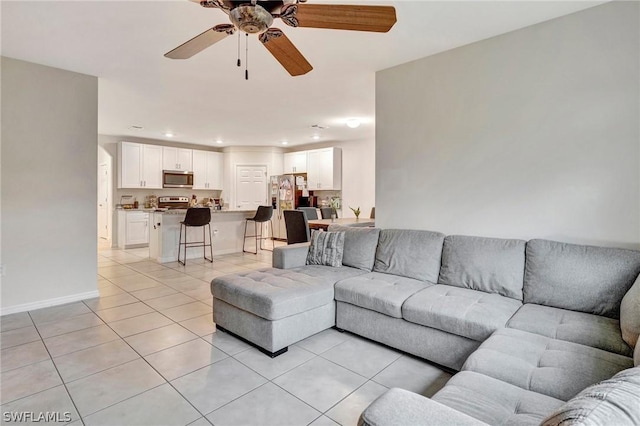 tiled living room featuring ceiling fan