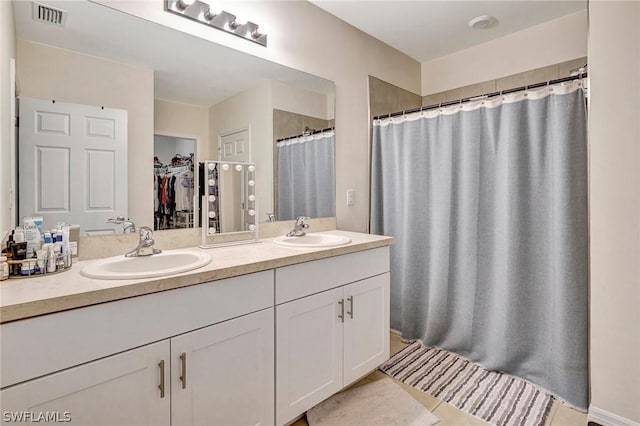 bathroom featuring vanity and a shower with shower curtain