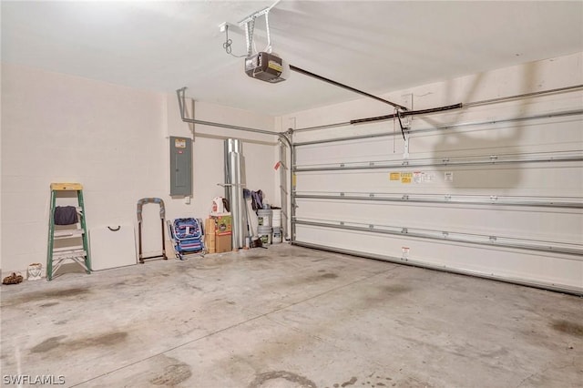 garage with a garage door opener and electric panel