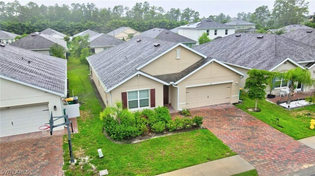 ranch-style home with a garage and a front yard