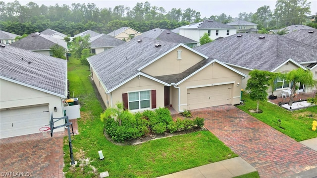 view of front of property featuring a garage and a front lawn