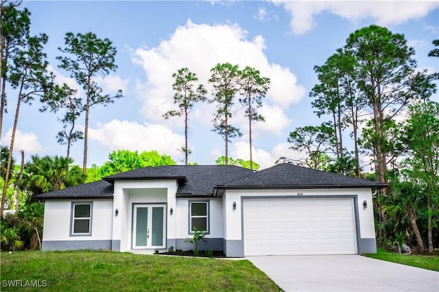 view of front of home with a front lawn, french doors, and a garage