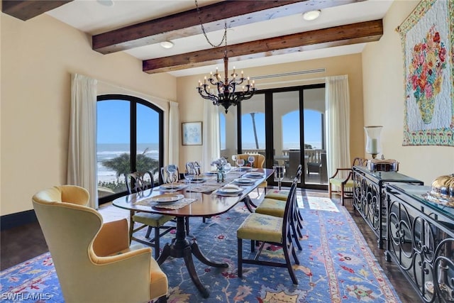 dining space featuring beamed ceiling, dark wood-type flooring, and a chandelier