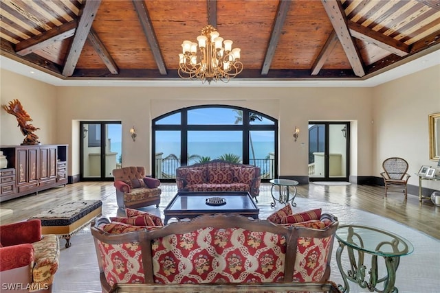 living room with wood ceiling, hardwood / wood-style flooring, an inviting chandelier, and beamed ceiling