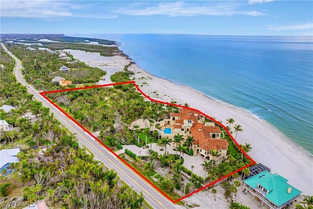 drone / aerial view with a beach view and a water view