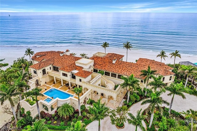 bird's eye view with a water view and a beach view