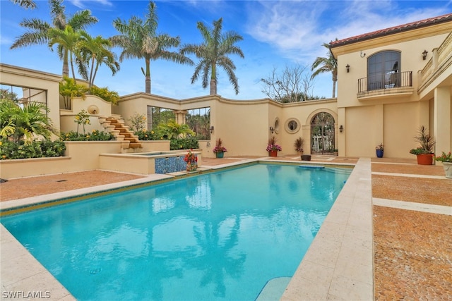 view of pool with an in ground hot tub and a patio area